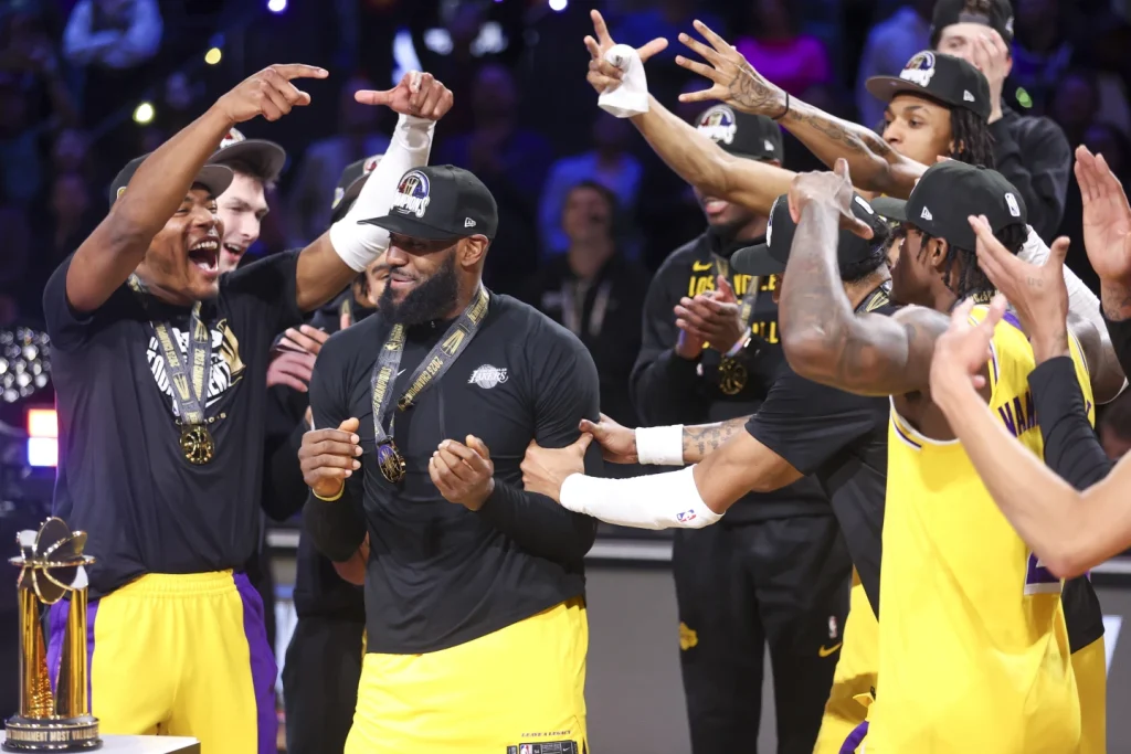 Los Angeles Lakers forward Rui Hachimura (left) celebrates with forward LeBron James after James was named NBA Tournament MVP after defeating the Indiana Pacers 123-109 in the NBA Basketball Inseason Tournament championship game on Saturday.